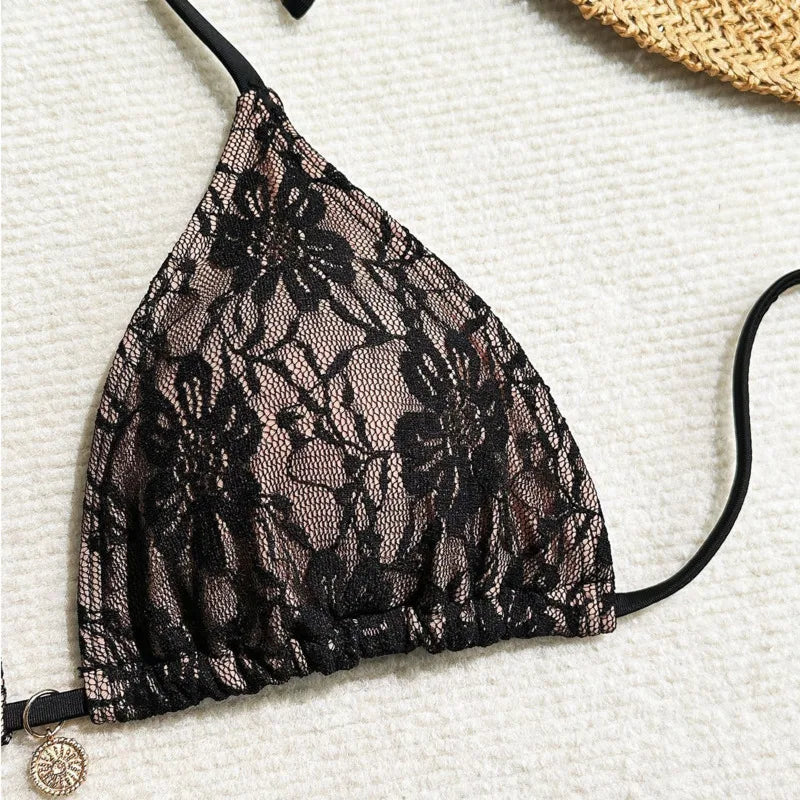 black lace triangle bikini top close up on beige linen