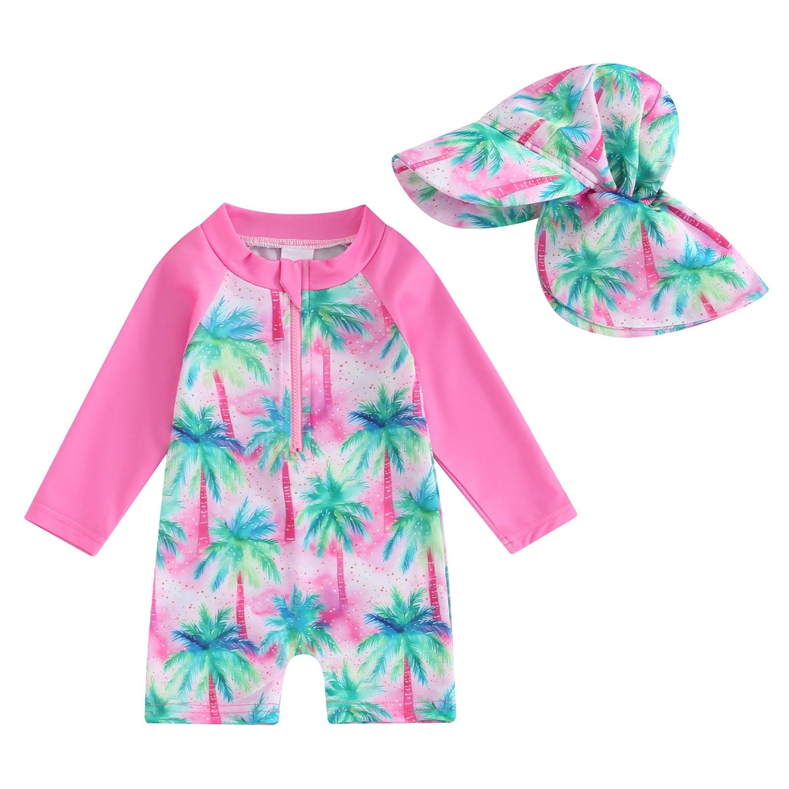 Toddler pink long-sleeve swimsuit with tropical palm tree print and matching pink sun hat for sun protection