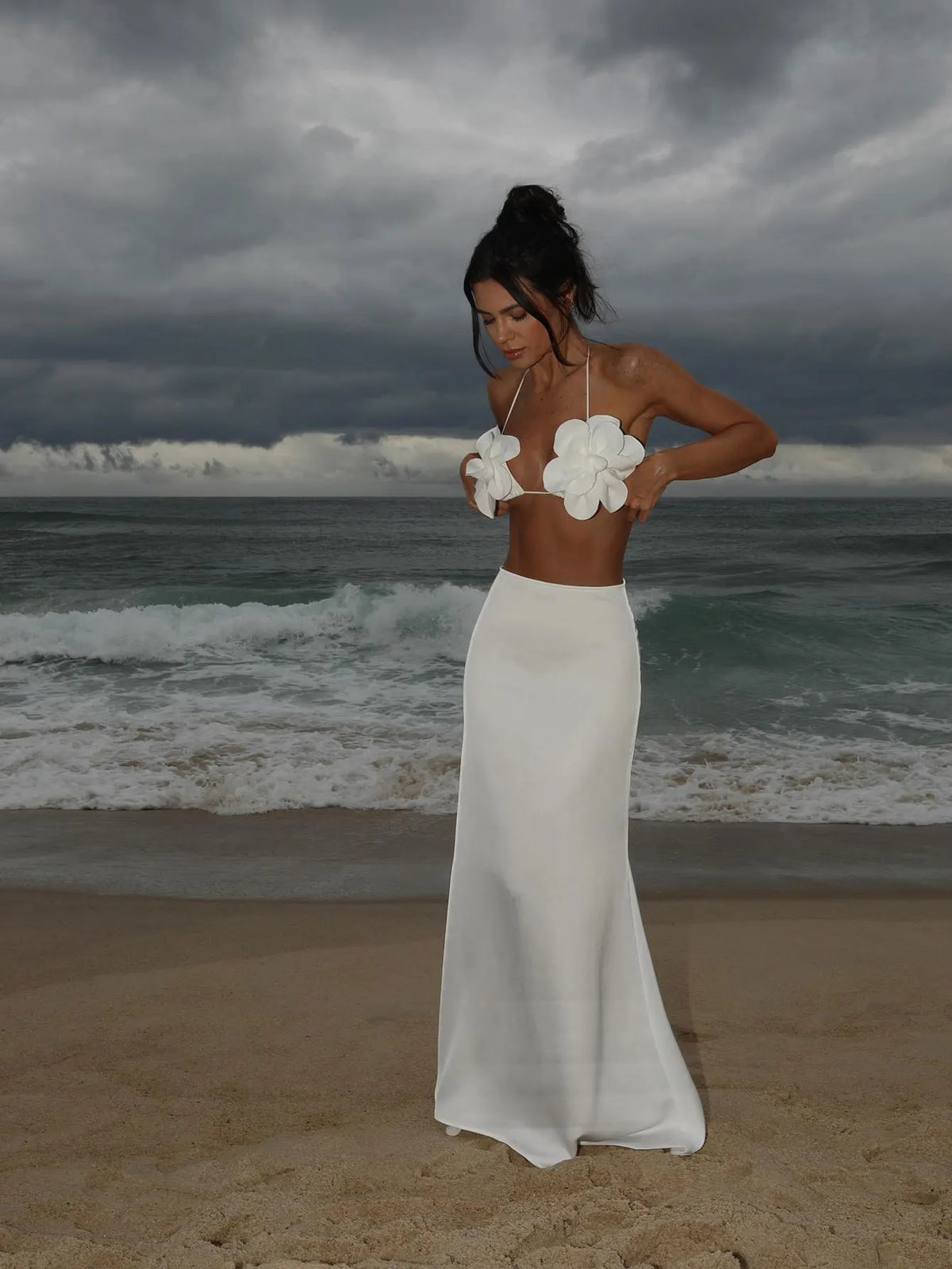 Model wearing the white floral applique bikini with a smooth solid white maxi skirt