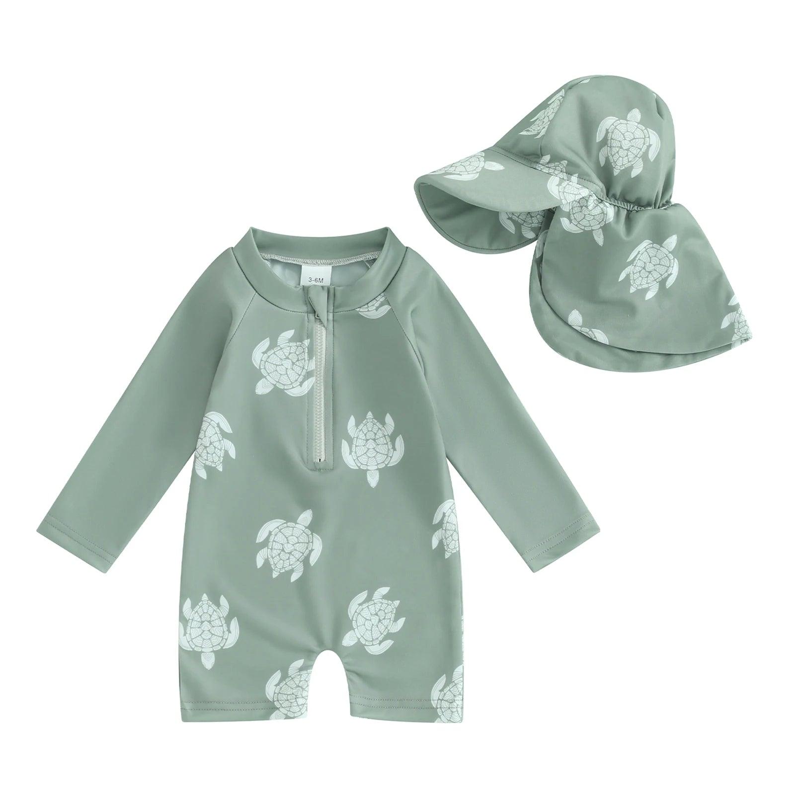 Toddler mint green long-sleeve swimsuit with white turtle prints and matching sun hat for floral tropical style