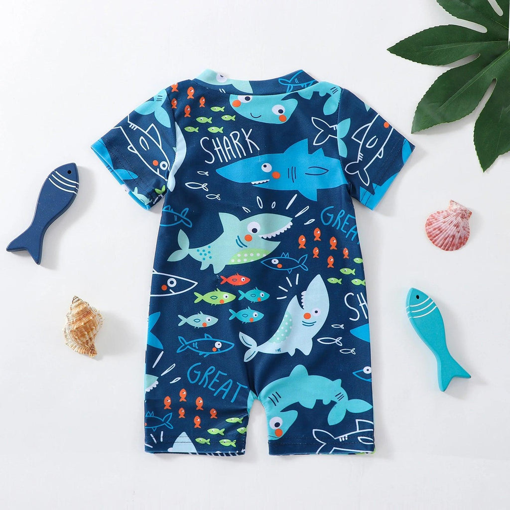 Navy blue toddler boys short-sleeve zipper swimsuit with playful shark and fish print and white shark lettering
