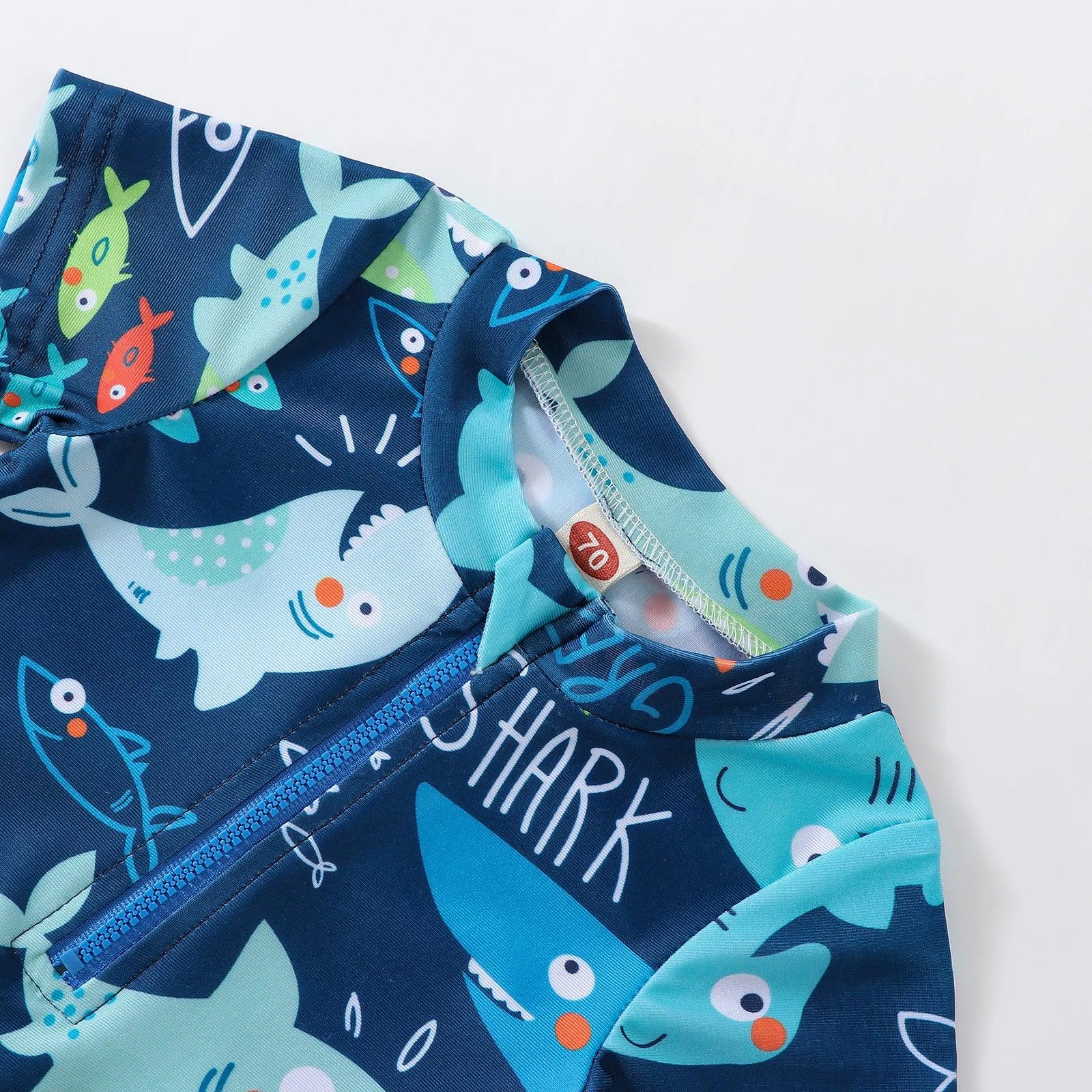 Toddler boys navy blue short sleeve zip-up rash guard with cartoon shark and fish print for swim use