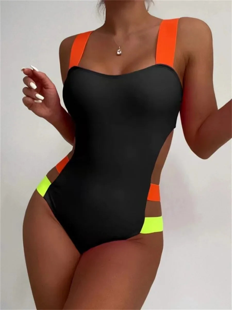 Black one-piece swimsuit with bold orange and neon yellow accent straps and hollow back design shown from the back