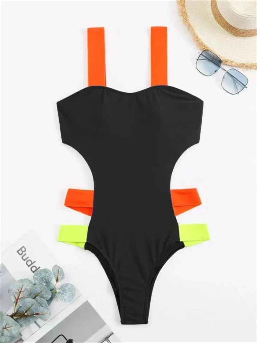 Black one-piece swimsuit with neon orange and green accent straps and hollow back shown from the back side