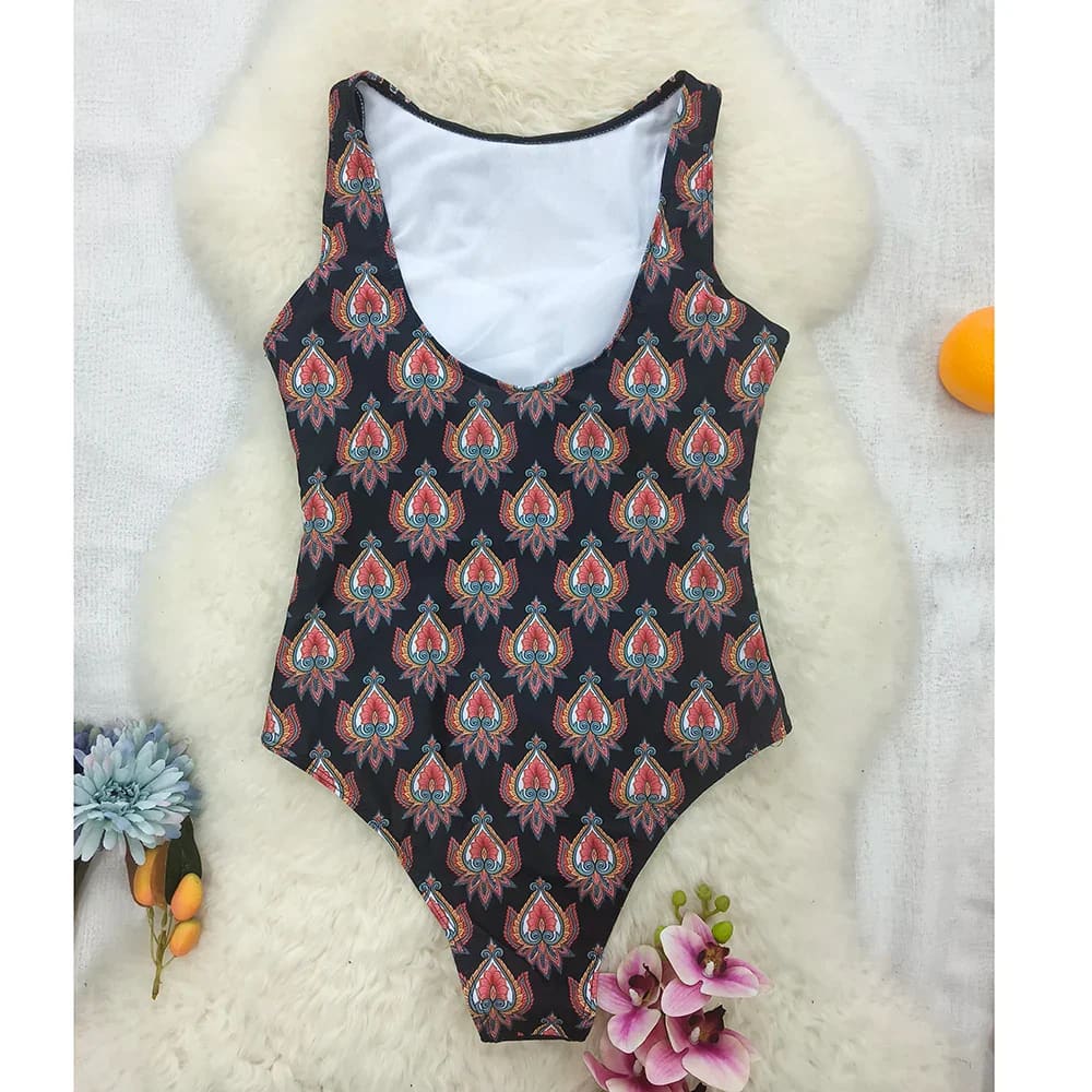 Black one-piece swimsuit with vibrant ethnic floral animal paisley pattern in red orange and teal shades