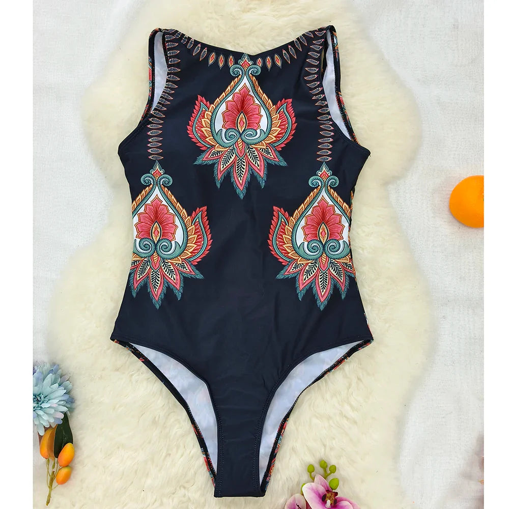 Black one-piece swimsuit with vibrant red orange and teal ethnic floral animal embroidery patterns