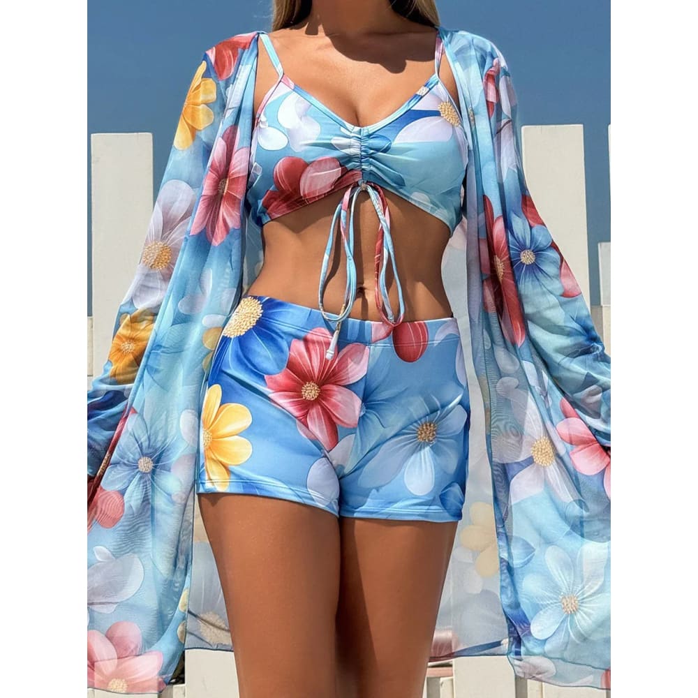 Blue floral print tie-dye bikini set with high-waist shorts and matching long-sleeved cover-up