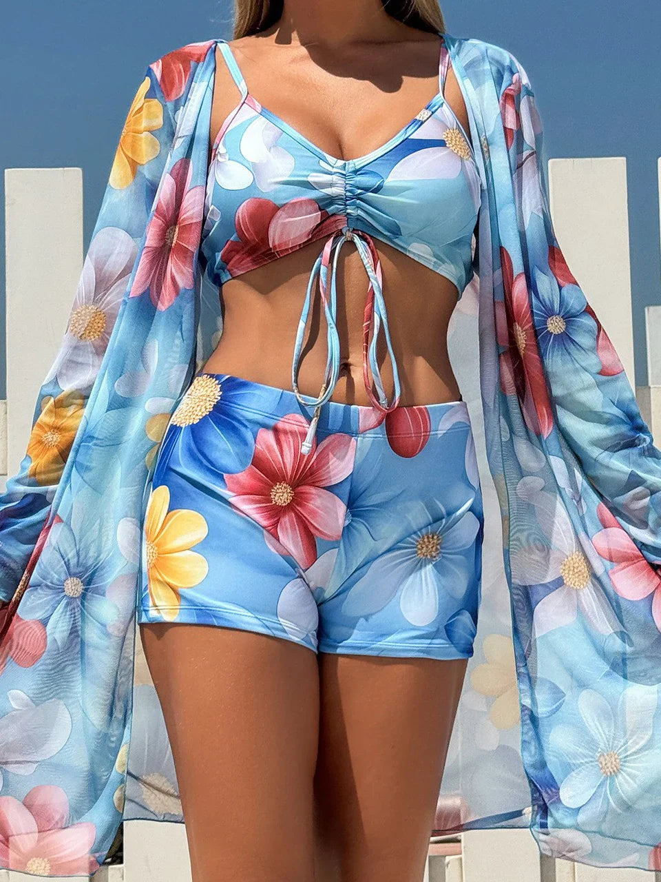 Blue floral print tie-dye bikini set with high-waist shorts and matching long-sleeved cover-up