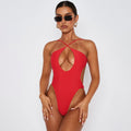 Red cross-cutout monokini one-piece with crisscross back strap and oval front cutout