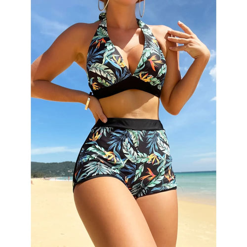 Printed halter high-waist bikini set with black triangle top, dark waistband, floral leaf shorts