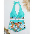 Halter high-waist printed short bikini set: turquoise top with orange tropical print shorts.