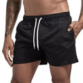 Quick-dry swim shorts, black with drawstring and side pocket openings