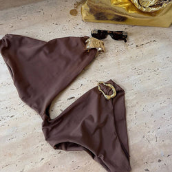 Brown one-shoulder cut-out monokini swimsuit laid flat