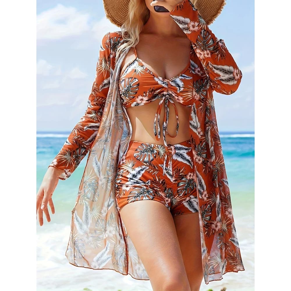Orange tie dye bikini set with high waist shorts and matching long sleeved cover up in tropical print