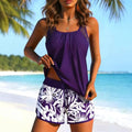 Two-piece swimsuit with purple and white tropical leaf print, solid purple waistband, high-waisted tummy-concealing flat-cut bottoms