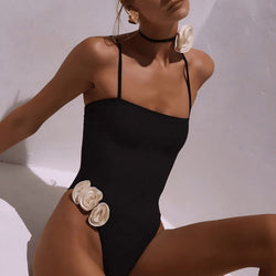 Black one-piece swimsuit with square neckline and thin spaghetti straps