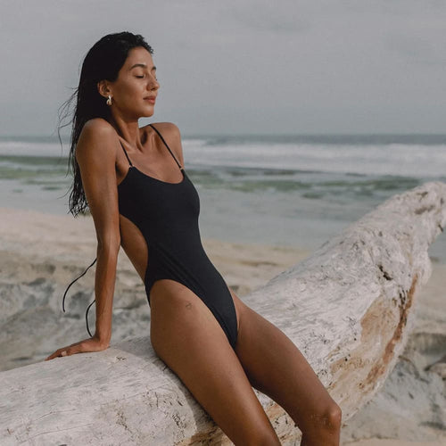 Black high-cut one-piece swimsuit, side view, thin spaghetti straps