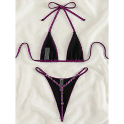 Purple halter triangle bikini top and micro thong bottom with bow and chain jewel trim