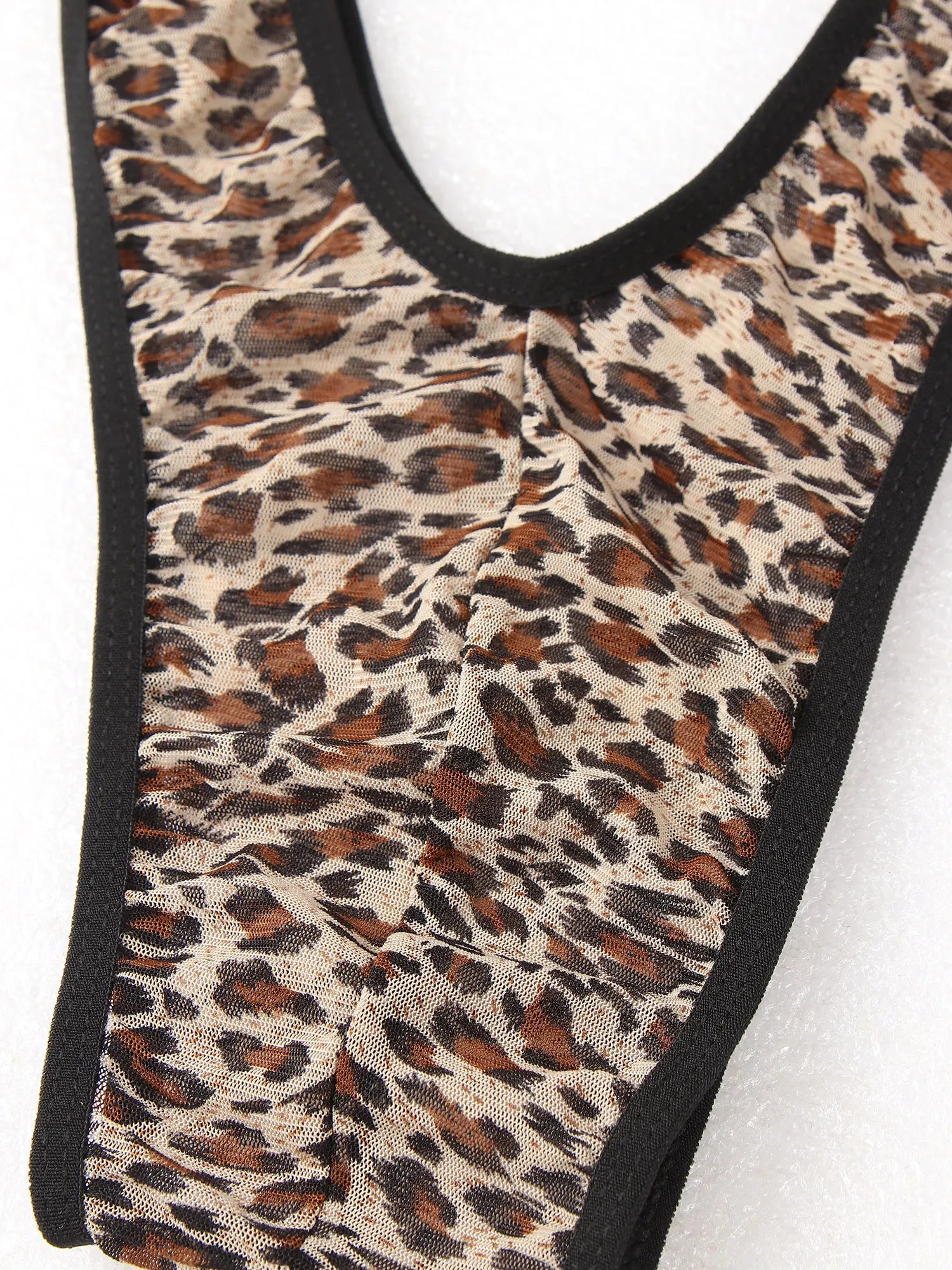 Leopard print fabric panel with black edging on monokini-style bodysuit