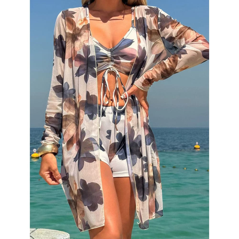 Sheer long-sleeved floral cover-up in soft beige with dark blue and pink flowers for tie-dye bikini set style