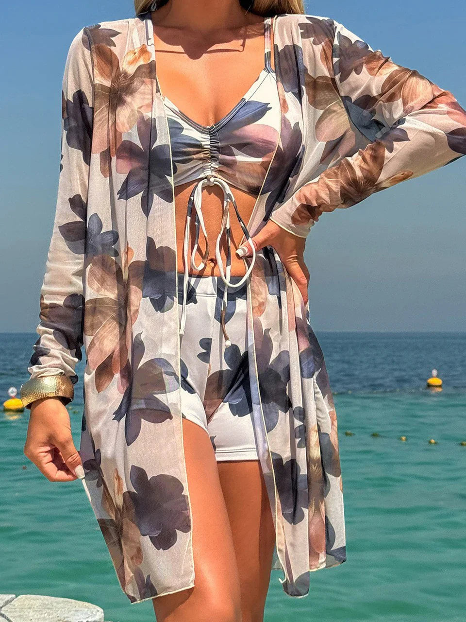 Sheer long-sleeved floral cover-up in soft beige with dark blue and pink flowers for tie-dye bikini set style