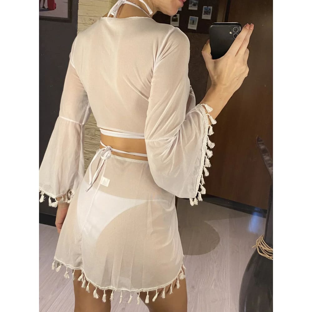 Sheer off-white boho tassel two-piece bikini set with long bell sleeves and fringed tassel skirt hem