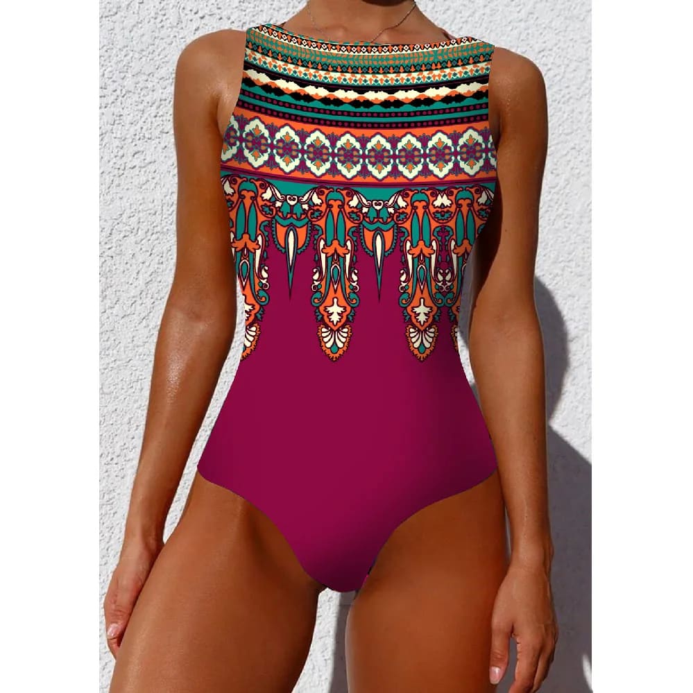 A vibrant magenta ethnic floral animal one-piece swimsuit with colorful tribal pattern and teal orange neckline accents
