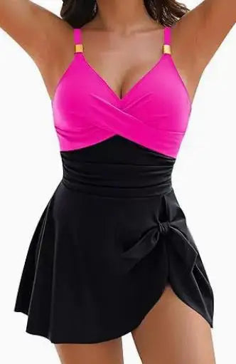 A vibrant pink and black tummy control swimdress one-piece with draped v-neck top and tied waist flared skirt