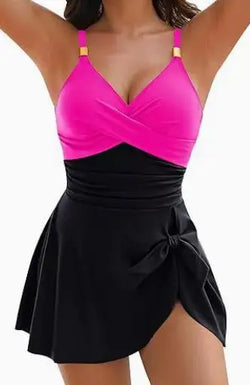 A vibrant pink and black tummy control swimdress one-piece with draped v-neck top and tied waist flared skirt