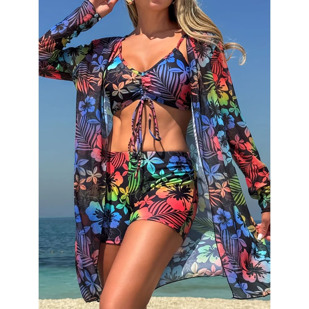Vibrant tropical floral tie dye bikini set with high waist shorts and matching sheer cover up for beachwear