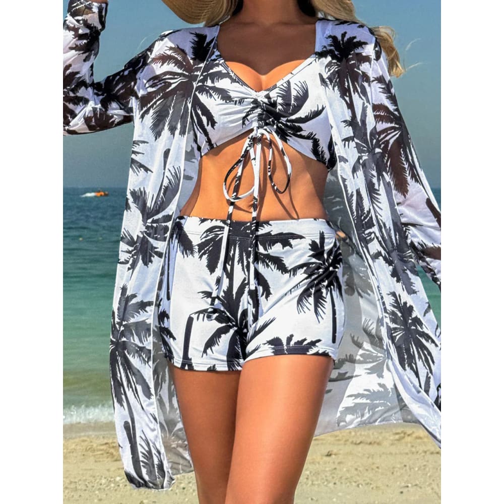 White and black palm tree printed 3-piece tie-dye bikini set with crop top shorts and long-sleeved jacket