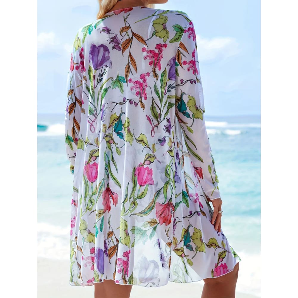 A flowing white dress with vibrant pink purple and green floral pattern complementing a tie-dye bikini set design