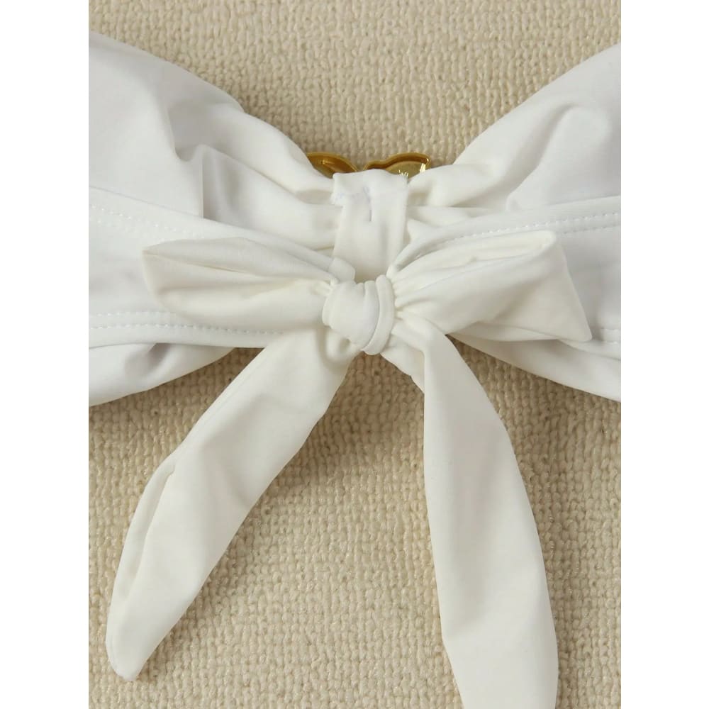 White fabric bow with gold-toned clasp on bandeau push-up brazilian thong bikini set for women