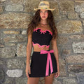 Black high-waist bodycon mini skirt with hot pink bow tie detail
