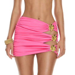 Pink ruched high-waist mini skirt with cutout sides and gold flower accents