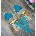 Turquoise patterned high-waist bikini with gold trim, triangle top with teal accents